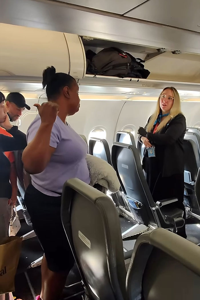 Woman refusing to let passengers exit airplane until her daughter goes first, causing outrage during flight disembarkment. Woman refusing to let passengers exit airplane until her daughter goes first, causing outrage during flight disembarkment.