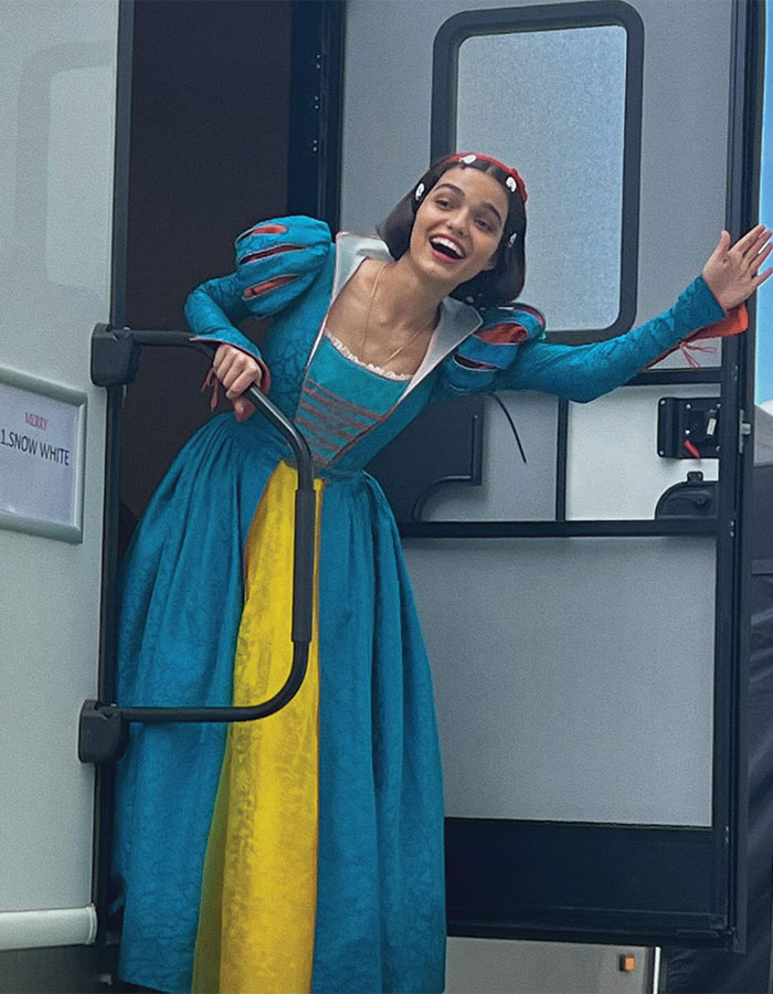 Actress dressed as Snow White smiling and waving while stepping out of a trailer on Disney reboot set. Actress dressed as Snow White smiling and waving while stepping out of a trailer on Disney reboot set.