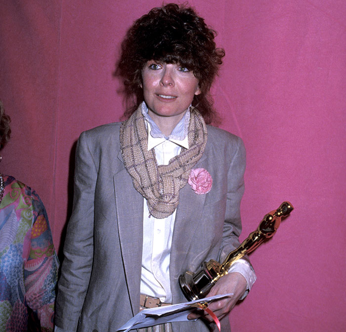 Diane Keaton holding an Oscar statue, with a scarf and gray blazer, representing chilling detail of last moments revealed in 911 call.
