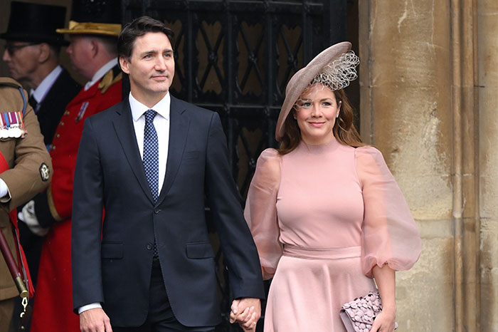 Justin Trudeau and wife holding hands at formal event, with focus on romance and midlife crisis keywords.