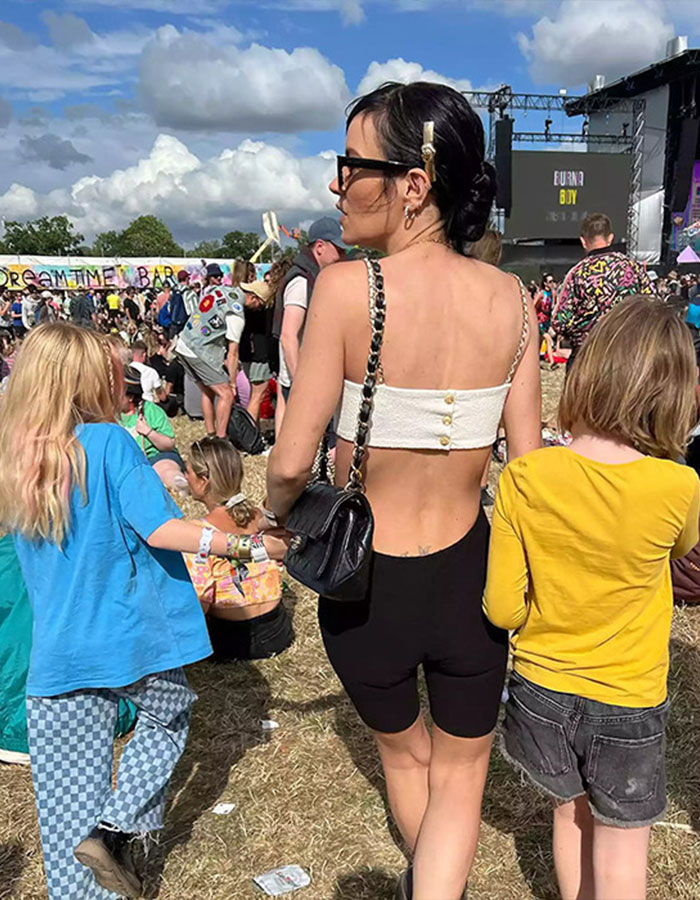 Lily Allen at an outdoor festival with children, capturing a candid moment that leaves fans intrigued about David Harbour.