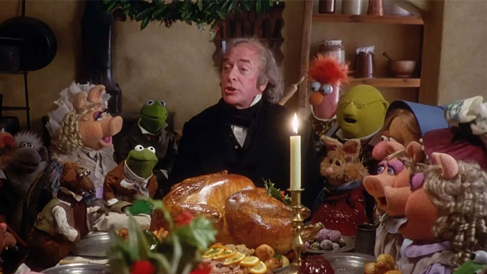 Scene from a movie featuring puppets and a man at a dinner table, referencing Johnny Depp movie role backlash and critics.