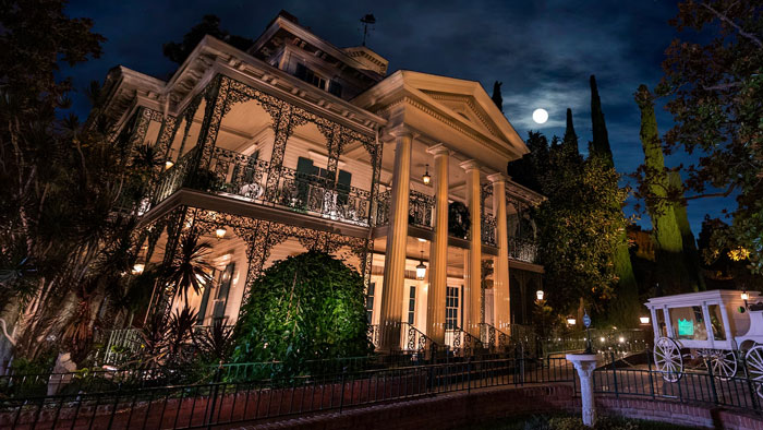 Haunted mansion attraction at Disney World at night under a full moon, related to visitors tragically lost lives.