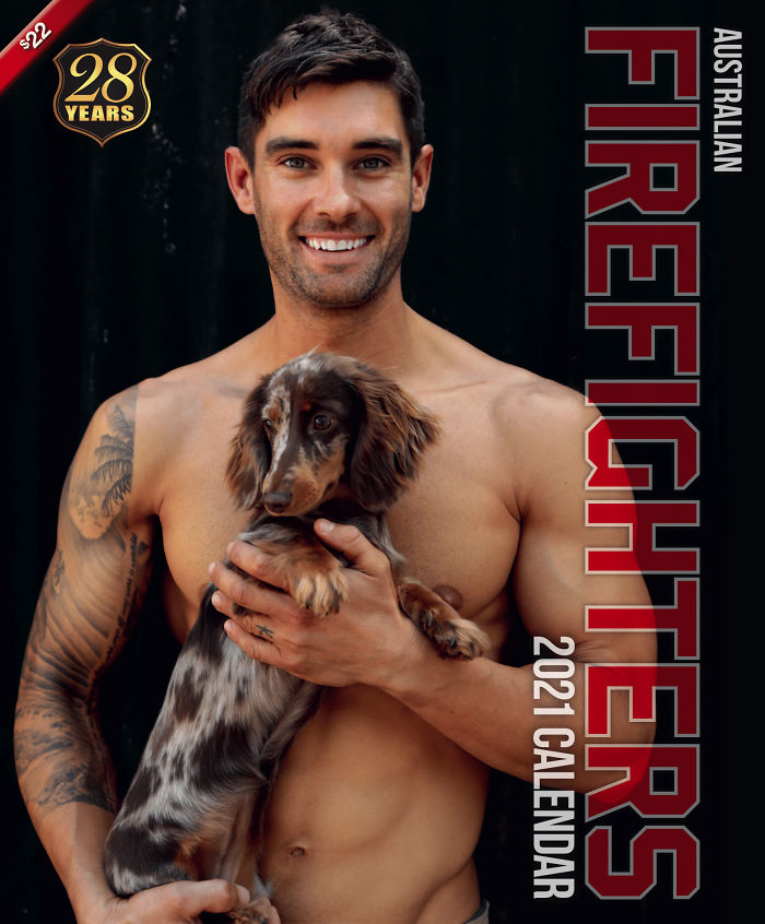 Shirtless firefighter holding an adorable dog for the Australian firefighters calendar, showcasing heroic firefighters and dogs.