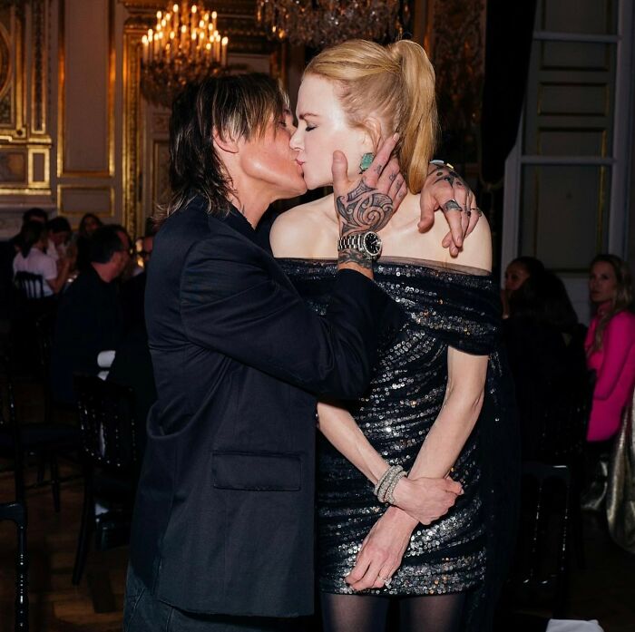 Nicole Kidman and Keith Urban sharing an intimate moment at a formal event with elegant lighting and decor.