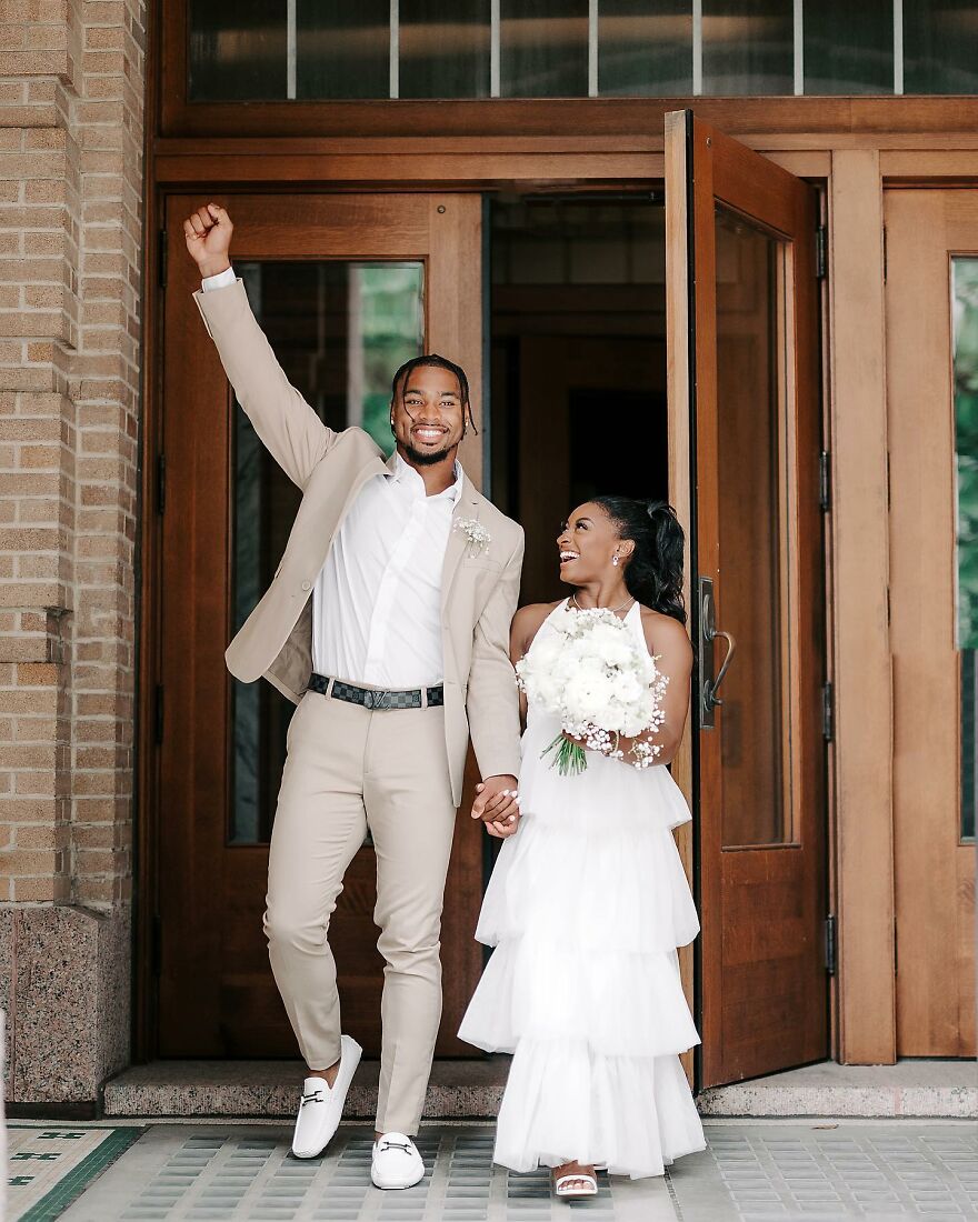 Jonathan Owens celebrating with partner in beige suit and white dress, highlighting net worth growth and power couple status. Jonathan Owens celebrating with partner in beige suit and white dress, highlighting net worth growth and power couple status.