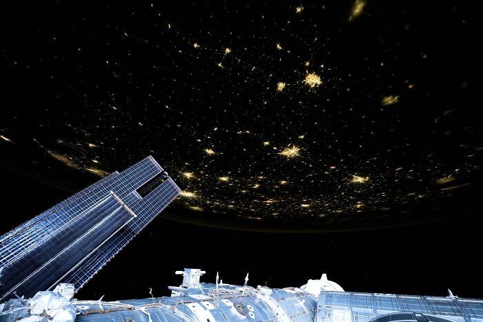 View of Earth’s city lights and space station exterior capturing epic astronomy photos of space’s beauty and mystery.