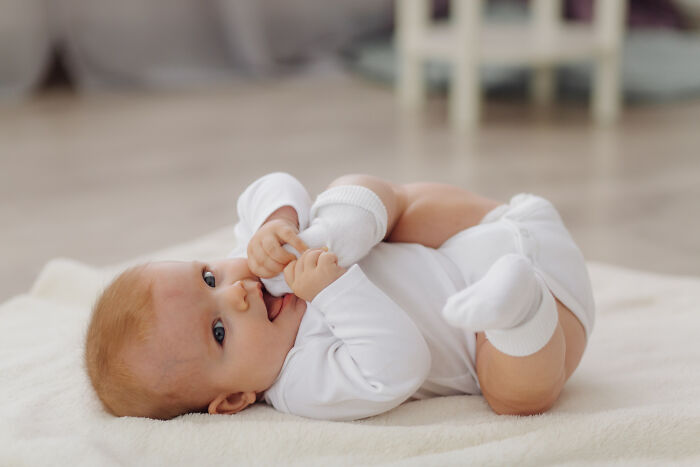 Baby lying on a soft blanket indoors, representing awareness of terrifying medical conditions without showing symptoms.