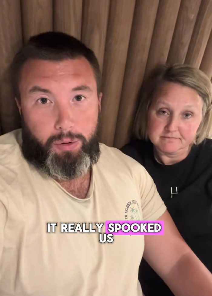 Man and woman looking concerned while sharing their experience about a disturbing discovery in a rental house.