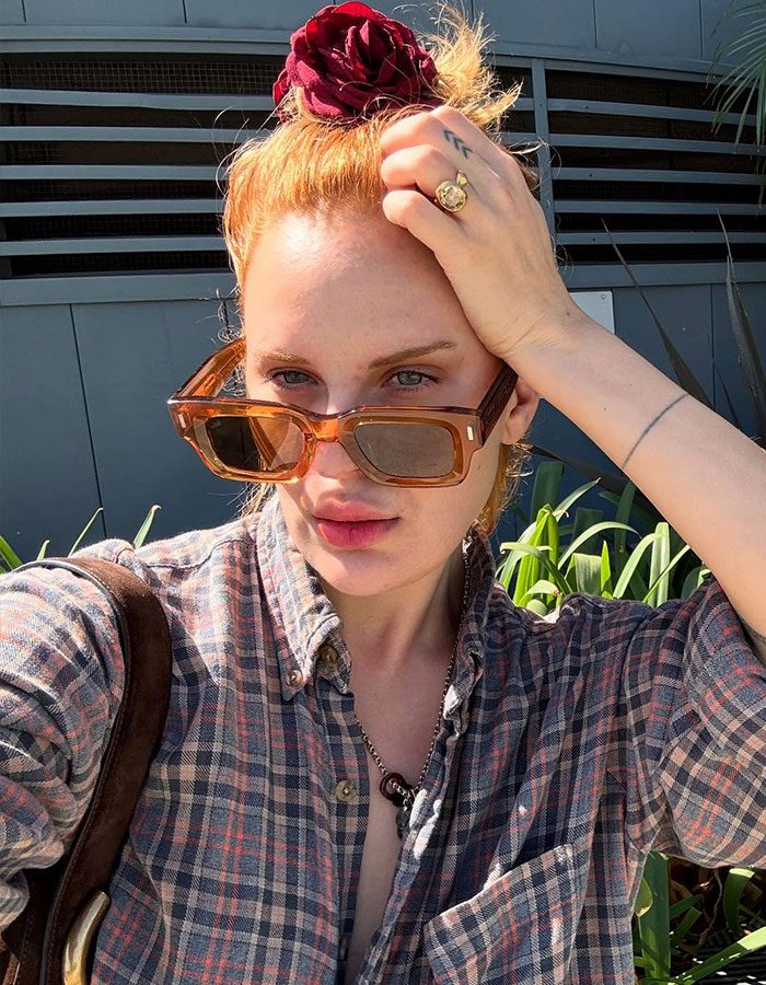 Bruce Willis' daughter wearing sunglasses and a plaid shirt taking a selfie outdoors with plants in the background. Bruce Willis' daughter wearing sunglasses and a plaid shirt taking a selfie outdoors with plants in the background.