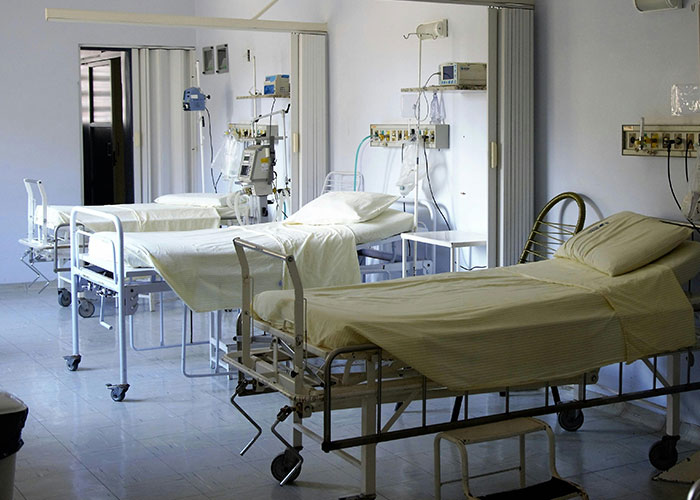 Empty hospital room with beds and medical equipment symbolizing clever loopholes used against horrible bosses.