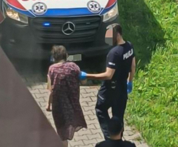 Police officer escorting a teen missing 27 years from parents&rsquo; house in a distressing condition near ambulance.
