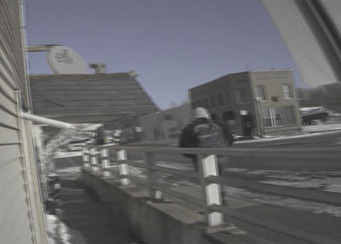 Blurred outdoor scene of a person walking near a snowy area, reflecting the story of 16YO dad and newborn baby.