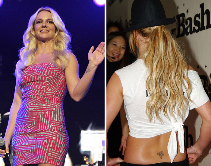 Female celebrity on stage wearing a patterned dress and showing tattoos in a casual outfit with a hat at an event.