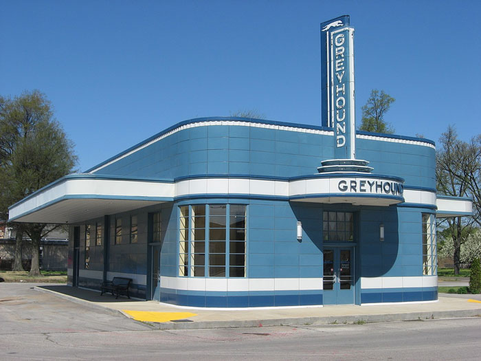 Vintage Greyhound bus station building with blue and white exterior, a notable place people wouldn’t revisit even if paid.