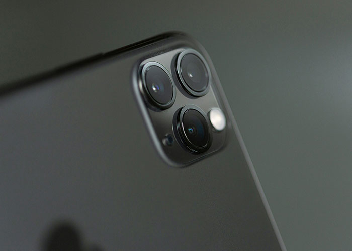 Close-up of a smartphone camera lens, illustrating creepy things women said or did to men that left them horrified.