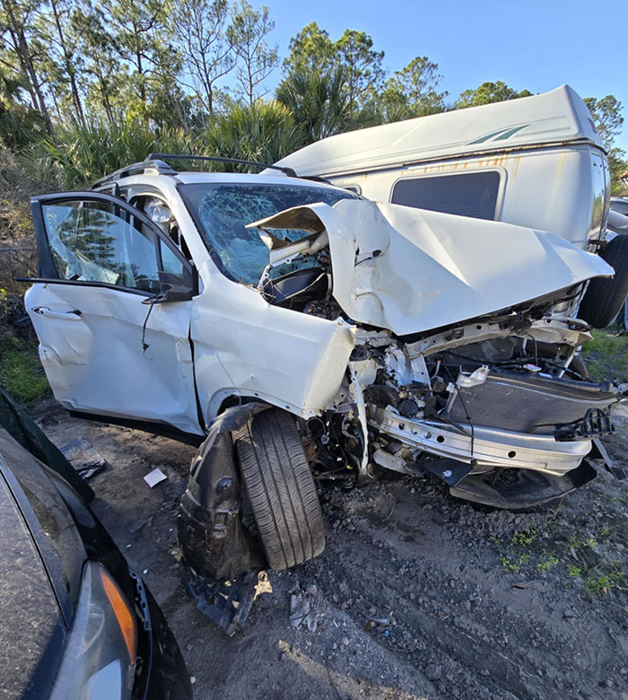 Severely damaged white SUV after crash, illustrating Florida dad-to-be wakes from coma story with scathing accusation context. Severely damaged white SUV after crash, illustrating Florida dad-to-be wakes from coma story with scathing accusation context.