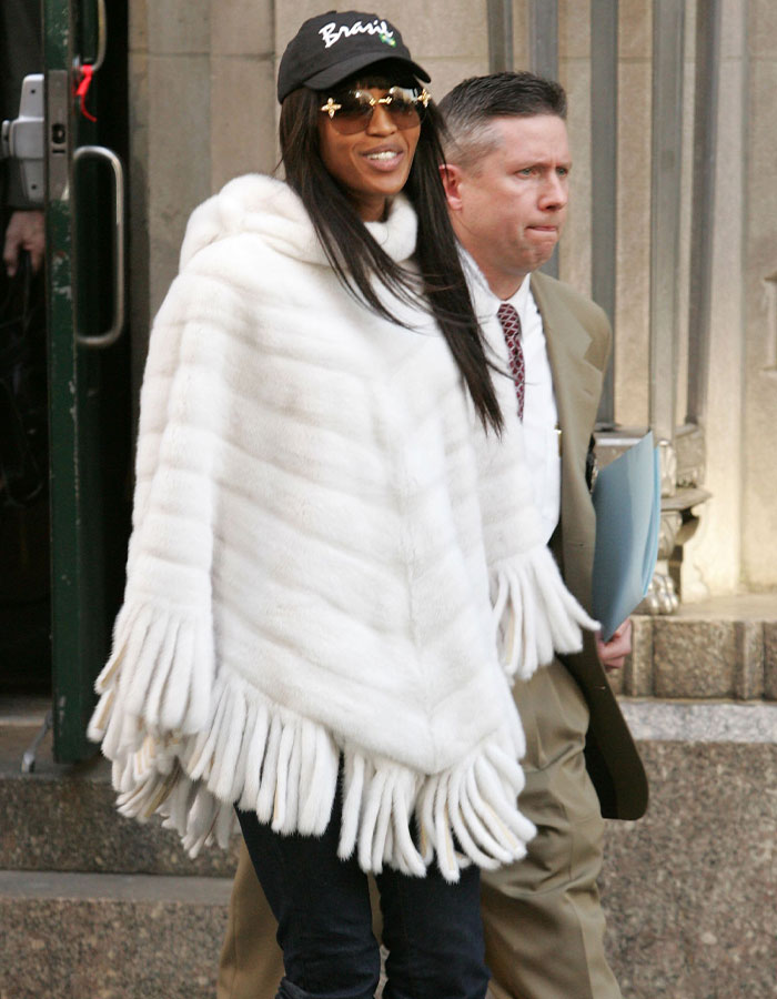 Celebrity wearing a white fringed poncho and sunglasses, highlighting tone-deaf celebs mocking others earning less.