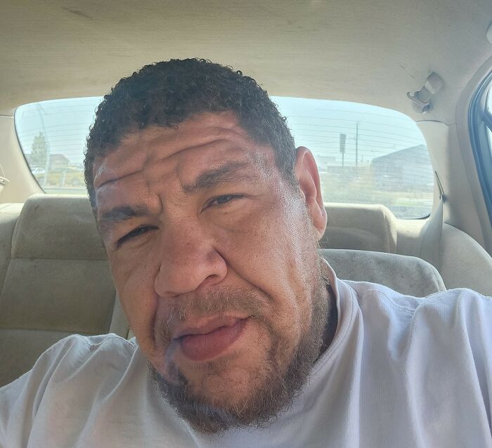 Plus-size activist sitting in the backseat of a car with a serious expression and wearing a white shirt. Plus-size activist sitting in the backseat of a car with a serious expression and wearing a white shirt.