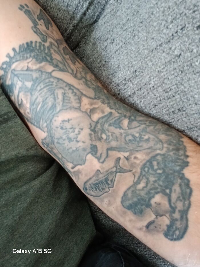 Arm tattoo featuring a mix of skeletal fish and animal designs, showcasing unique tattoos people allowed on their bodies.