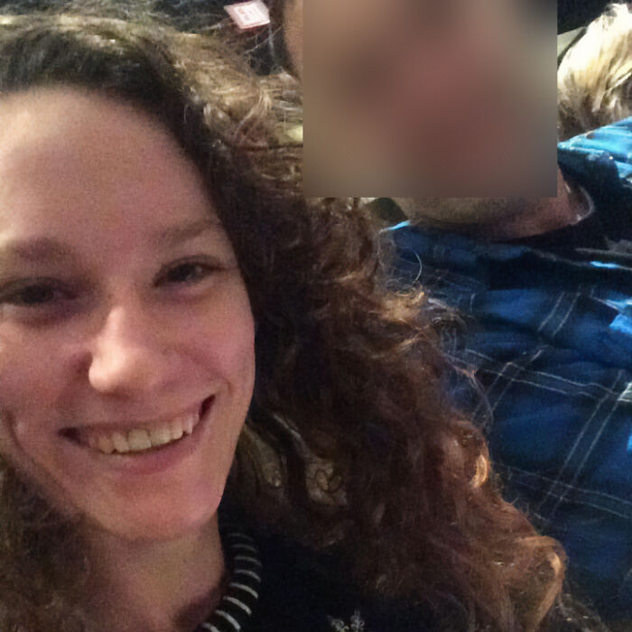 Smiling woman with curly hair sitting next to a man in a casual setting, related to friend with benefits cooler and kid.