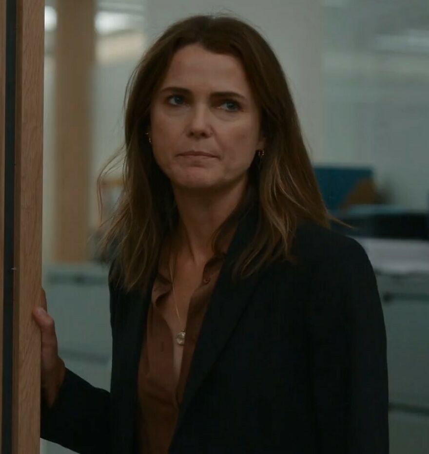 Keri Russell, 49, wearing a black blazer and brown shirt, expressing concern about Hollywood's growing plastic surgery trend.