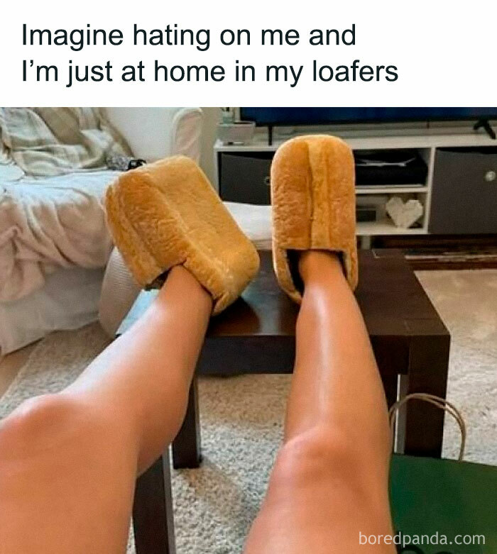 Legs resting on a table wearing loafers that look like bread in a funny Thunder Dungeon meme about being at home.