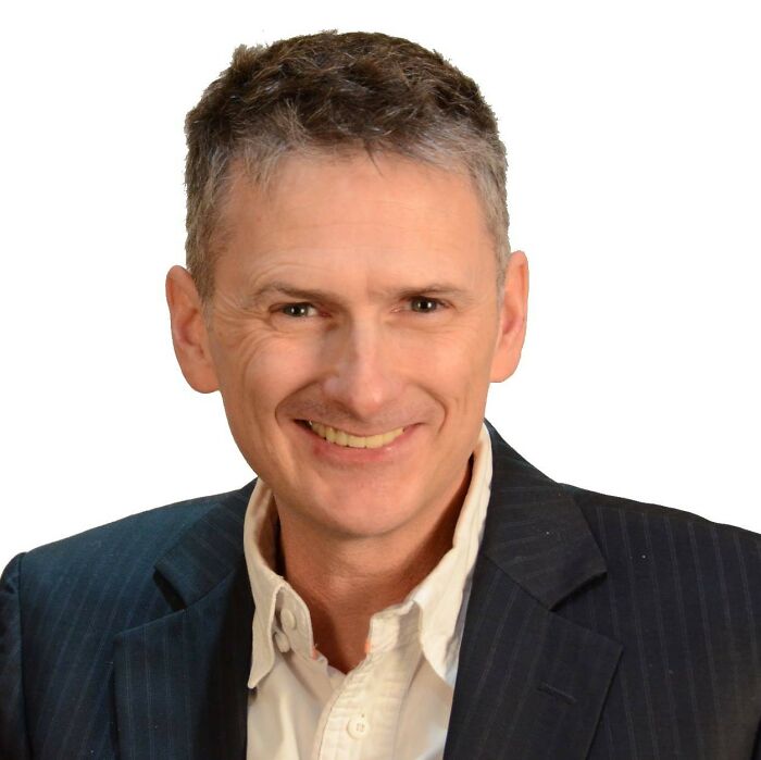 Smiling man in a dark suit and white shirt representing TV star facing capital punishment news in China. Smiling man in a dark suit and white shirt representing TV star facing capital punishment news in China.