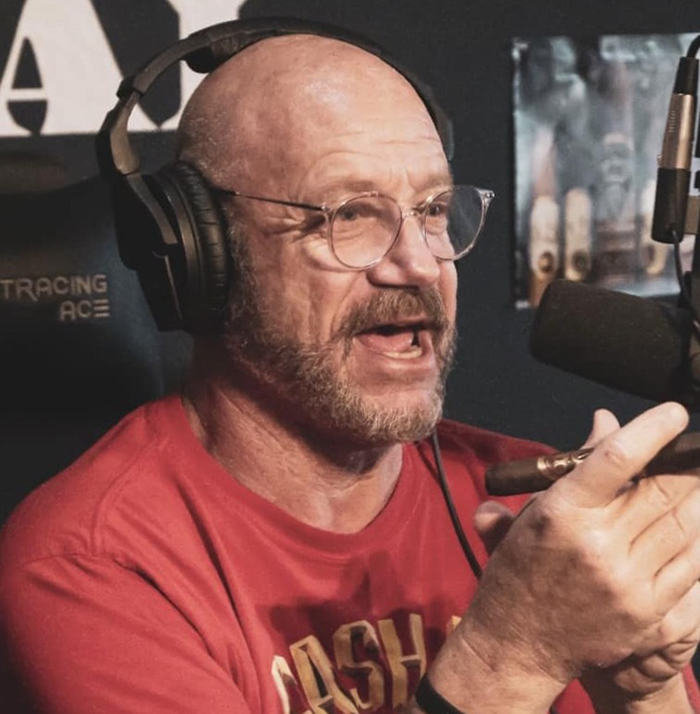 Man with glasses and headphones speaking into a microphone, discussing America&rsquo;s most notorious jewel thief and smuggling tricks.