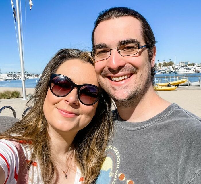 Couple smiling outdoors near waterfront, highlighting Disney superfan who shared major life update months before body found.