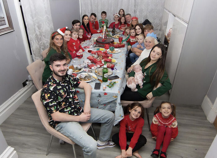 Large family gathered for a festive holiday meal, highlighting parents of 22 dealing with Disney vacation court issues.