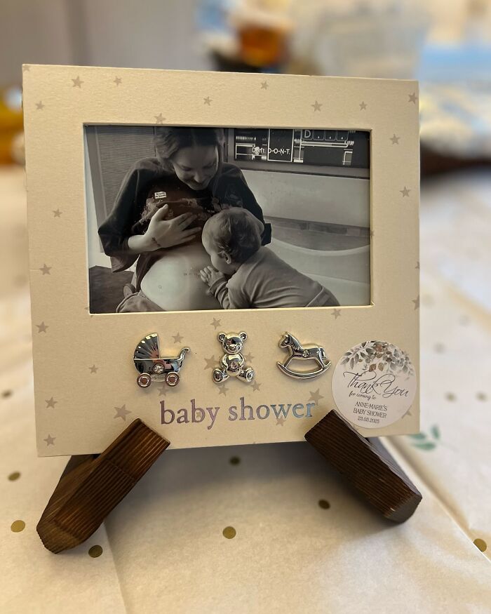 Baby shower photo frame with a black and white image of a mother and child, highlighting diabetes and pop star news.