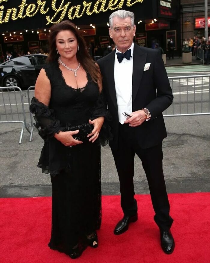 Pierce Brosnan's wife on the red carpet showing off a slimmer-than-ever frame wearing a black elegant dress and jewelry. Pierce Brosnan's wife on the red carpet showing off a slimmer-than-ever frame wearing a black elegant dress and jewelry.