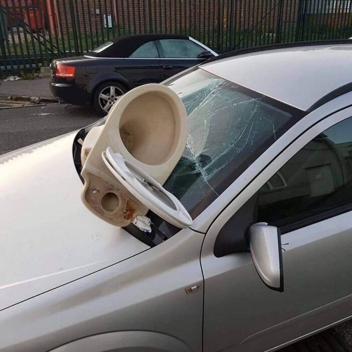Toilet smashed through car windshield, humorous image from 73 images that might need a priest or an exorcist collection.