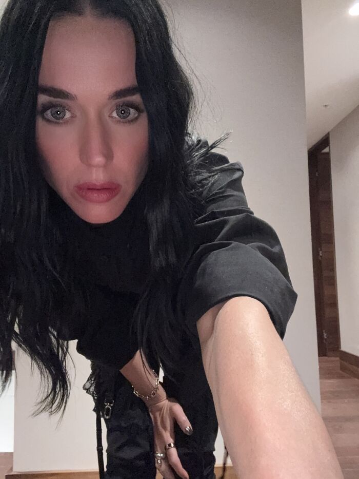 Katy Perry taking a close-up selfie indoors, dressed in black, related to Justin Trudeau romance news.