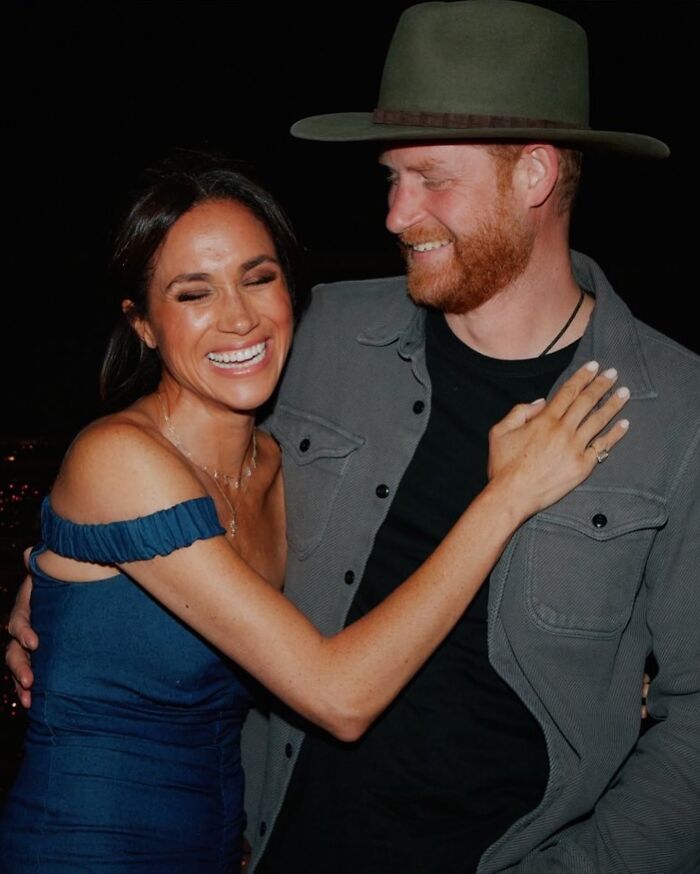 Meghan Markle smiling and embracing a man, highlighted during her Paris Fashion Week appearance sparking reactions.