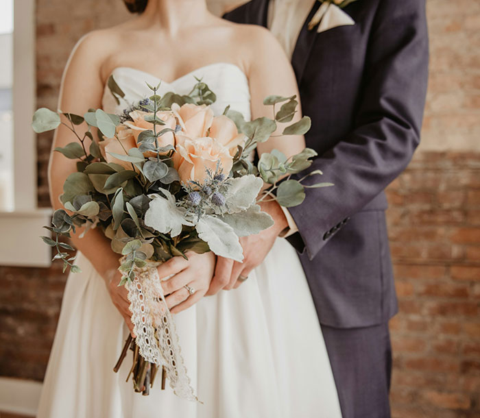 Bride and groom holding a bouquet, illustrating a wedding theme related to UK health guidance on marrying cousins.