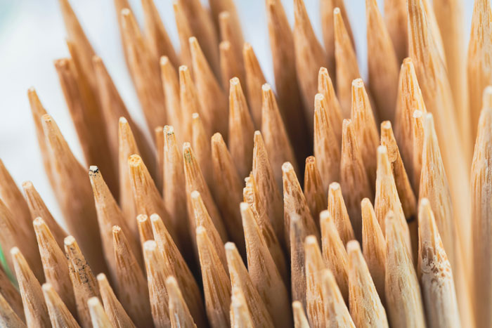 Close-up of wooden toothpicks with sharp tips, illustrating hilarious instances of people being unaware of common knowledge.