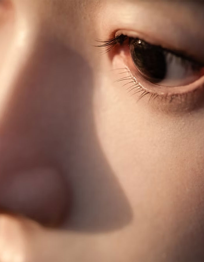 Close-up of an eerie new robot's eye and face, sparking debate about technology advancing too far.