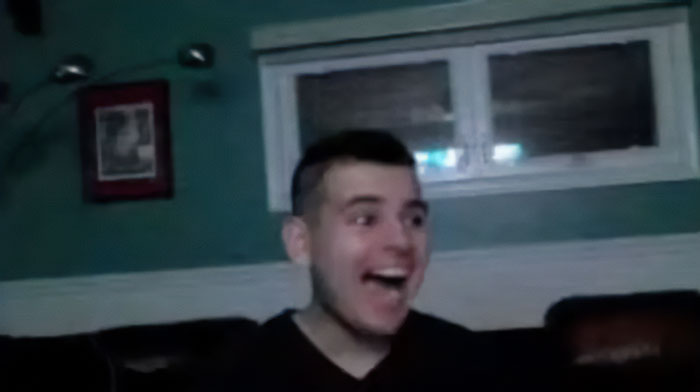 Teen driver in a dimly lit room smiling, linked to fatal hit-and-run case possibly tried as adult after public outrage.