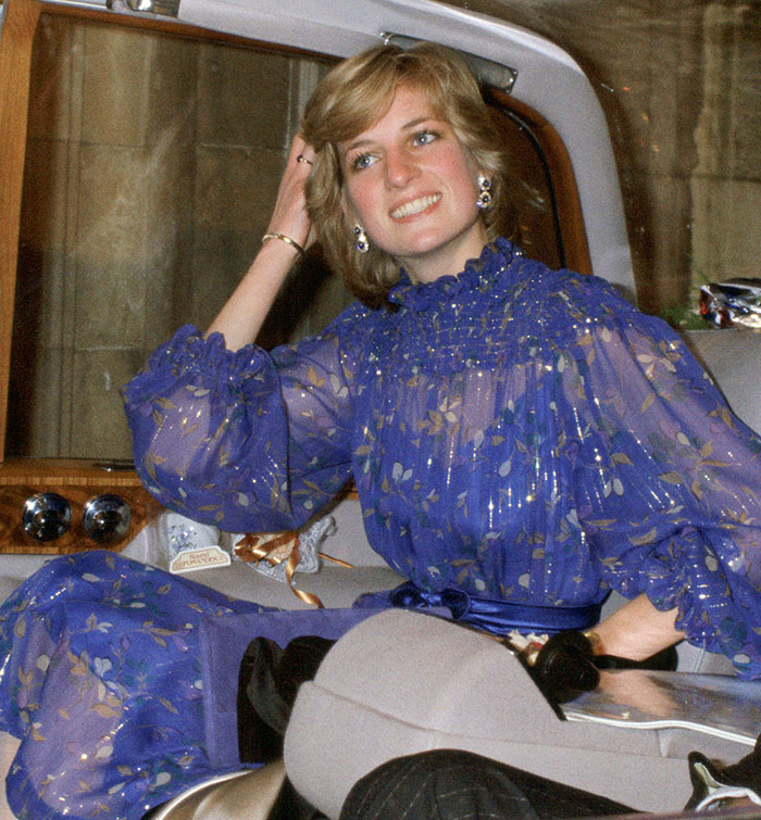 Woman in a blue floral dress smiling while sitting in a car, related to backlash over Meghan Markle's video and classier praise. Woman in a blue floral dress smiling while sitting in a car, related to backlash over Meghan Markle's video and classier praise.