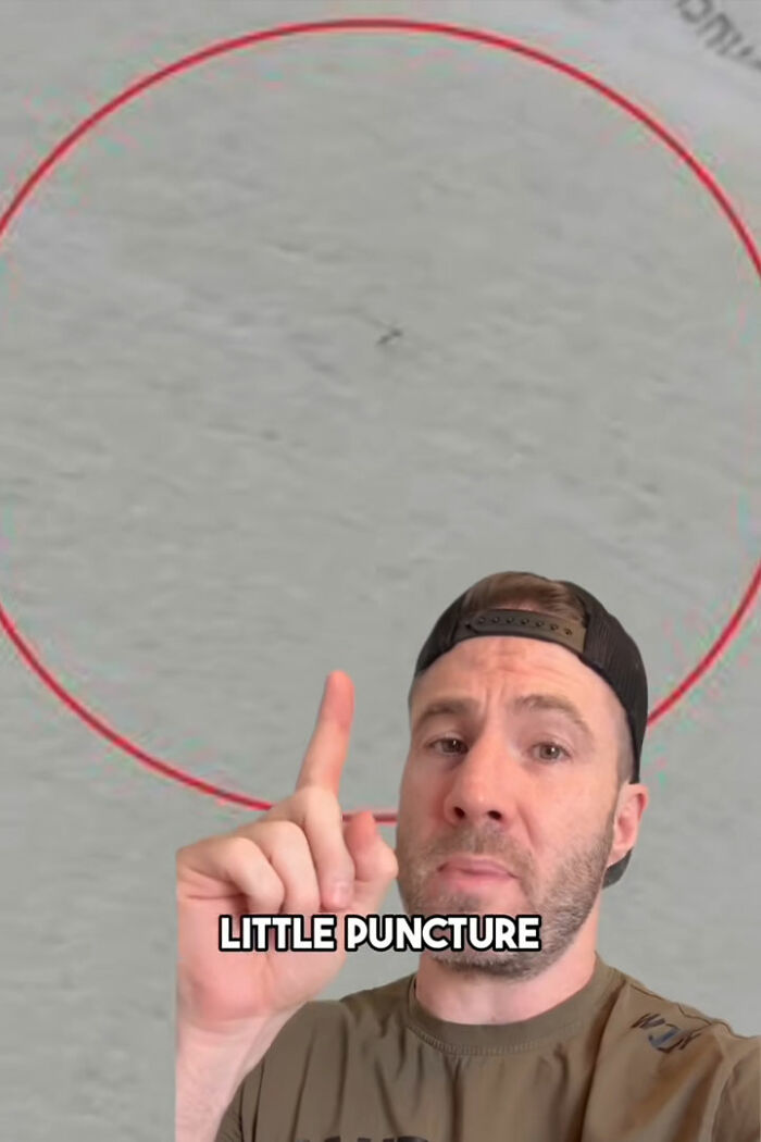 Man pointing at a small puncture on toilet paper, highlighting toilet paper danger in public bathrooms.