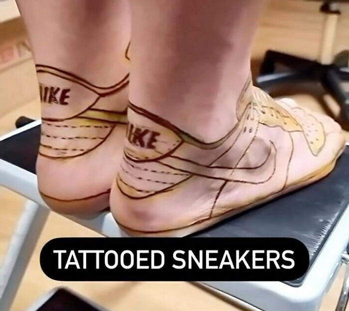 Feet with awful tattoos designed to look like worn Nike sneakers, highlighting bad tattoo choices and regrets.