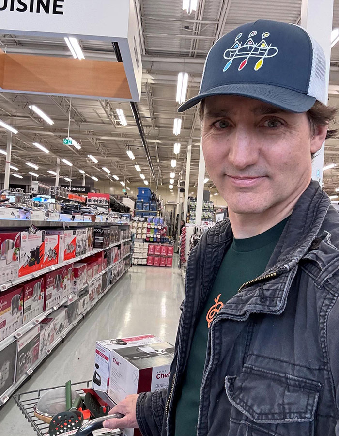 Justin Trudeau shopping in a store, wearing a hat and jacket, amid rumors of romance and midlife crisis after divorce.