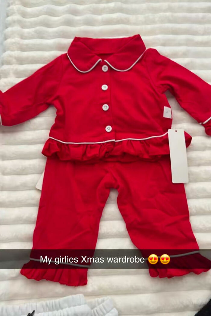 Red baby doll clothes laid out flat on a white textured surface, related to woman's outrageous 10-month lie.