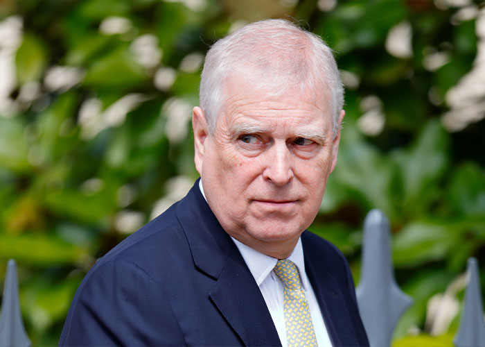 Prince Andrew outside, wearing a dark suit and patterned tie, amid new allegation reports linked to Virginia Giuffre memoir.