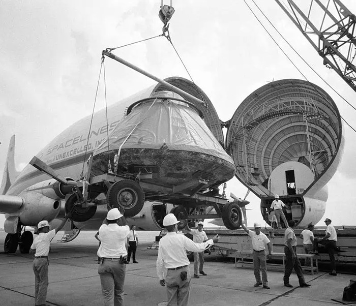 Vintage black and white photo showing a spacecraft being loaded, related to the 1969 moon landing conspiracy discussion.
