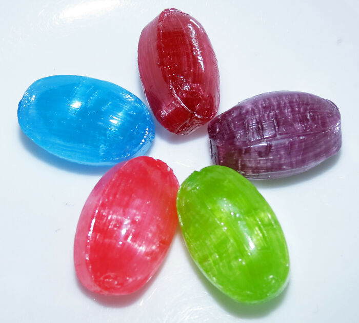 Colorful hard candies arranged in a circle on a white surface illustrating near-death experiences concept visually