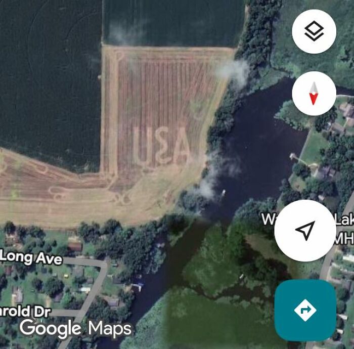 Aerial view of a field with the word USA carved into the land captured on Google Earth and Maps.