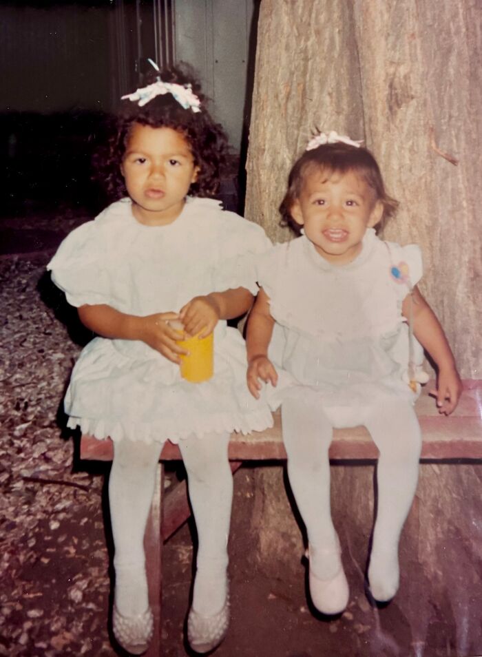 Two young sisters in white dresses sitting on a bench, representing the miracle of sisters discovered alive after 36 years.